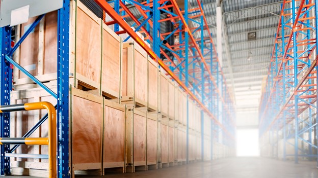 A warehouse filled with neatly stacked boxes and shelves, efficiently organized with the help of a Morn cargo lift.